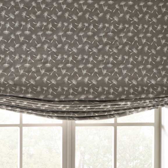 a window with a roman shade with a dandelion pattern on it Simply Windows.