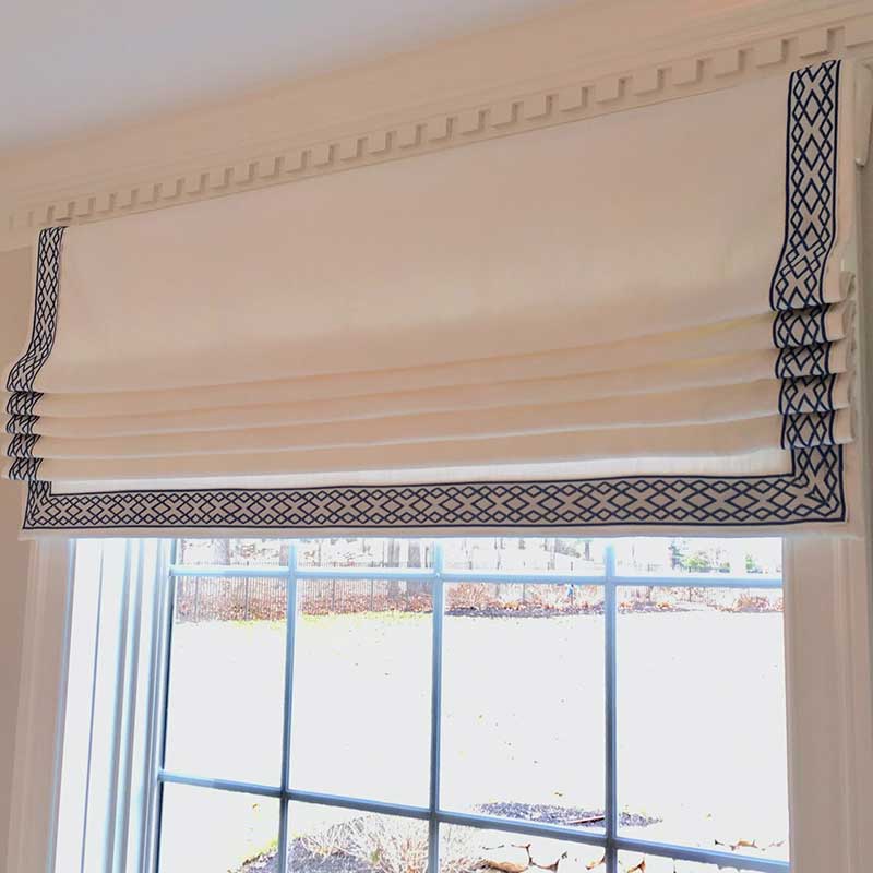 a window with a roman shade on it and a black trim Simply Windows.