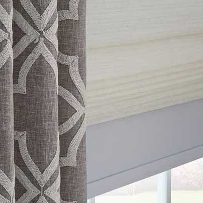 a close up of a pair of curtains and a roman shade on a window Simply Windows.