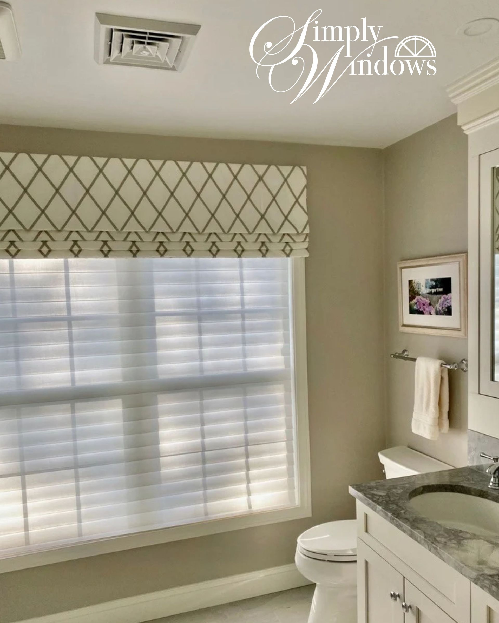 Bright bathroom with window blinds, patterned valance, white vanity, and granite countertop.