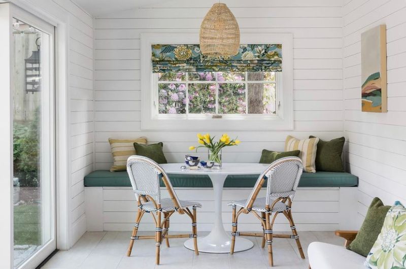 A closed patio has custom designer fabrics for roman shades, pillows and cushions. 
