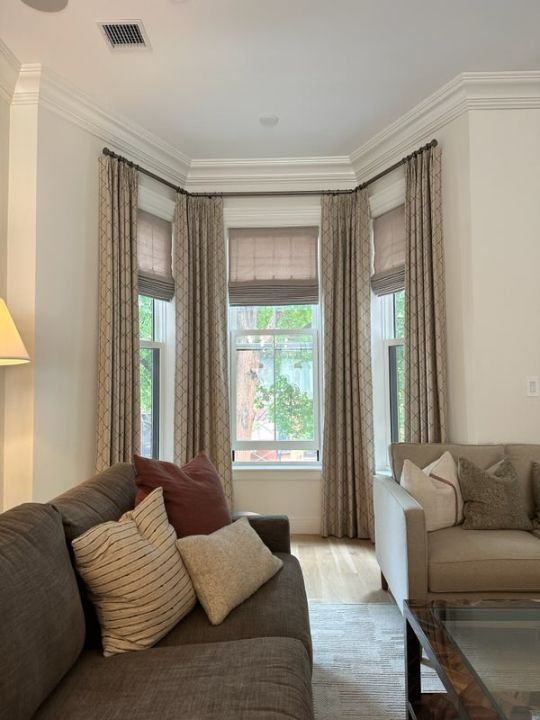 a living room with a couch and two windows with designer fabric drapery Simply Windows