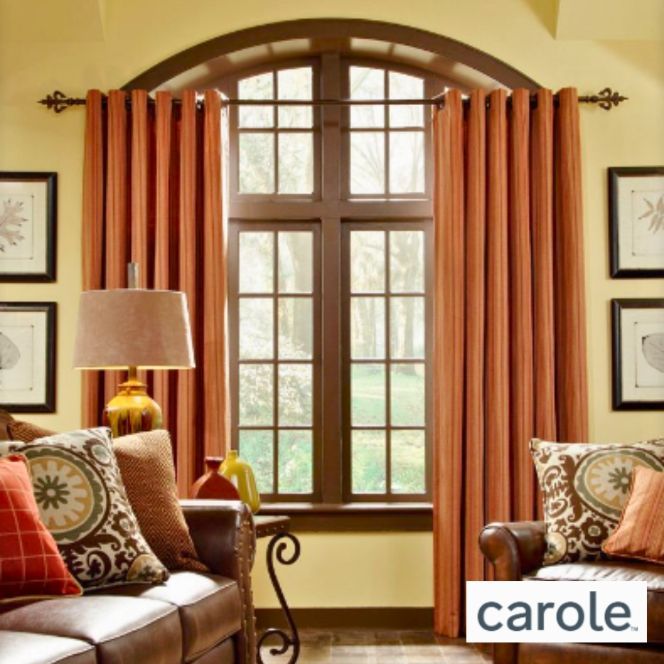 a living room with a couch a lamp and a window with orange curtains from carole made with designer fabrics Simply Windows