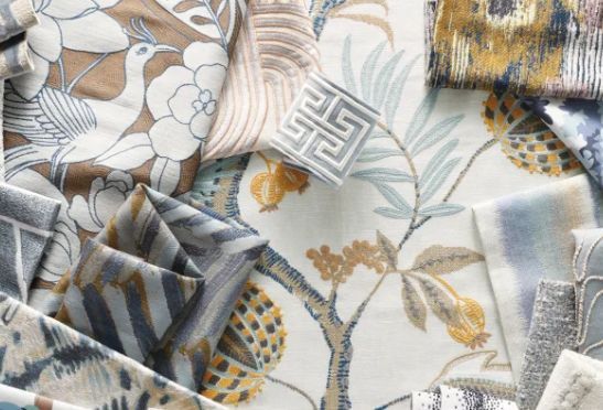 Assorted fabric swatches in beige, blue, and brown with various patterns, including florals, stripes, and geometric designs.