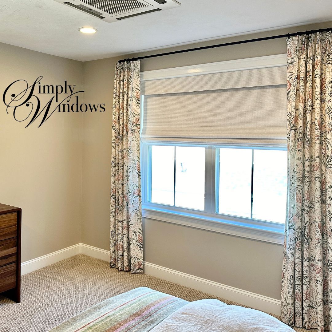 Modern room with beige walls, roman shades, custom drapery with designer fabrics, and a striped rug