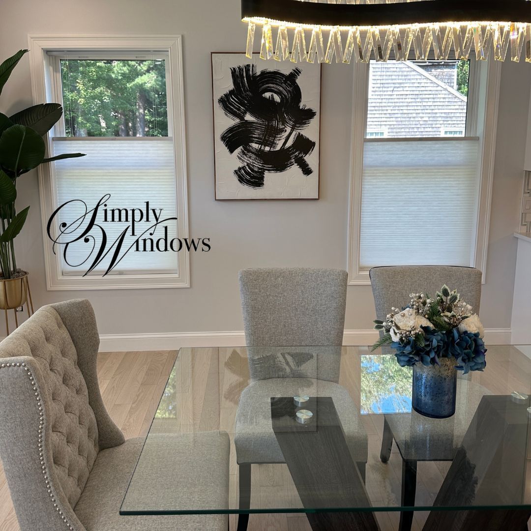 An elegant dining room in black and white has simple honeycomb shades on the windows - simply windows, ma