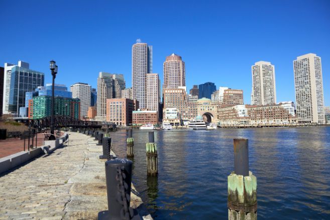a city skyline is visible over a body of water Simply Windows