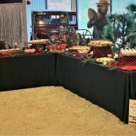 Harvest display of fruits and vegetables on a table with a farm-themed backdrop