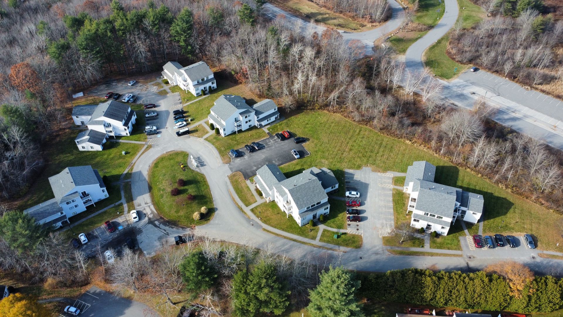 an aerial view of a residential area with houses and trees