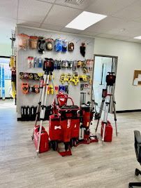 Laser levels and hand tools neatly displayed in showroom with clean floors and white walls.