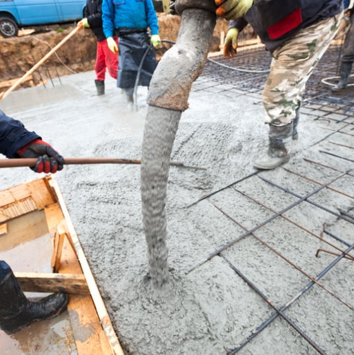 Concrete building supplies being used to pour reinforced concrete foundation. Concrete building supplies being used to pour reinforced concrete foundation.