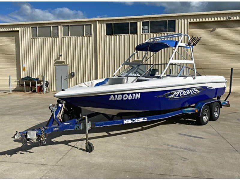 A Blue and White Boat is Parked in Front of a Building — A Plus Automotive Electrical in Lavington, NSW
