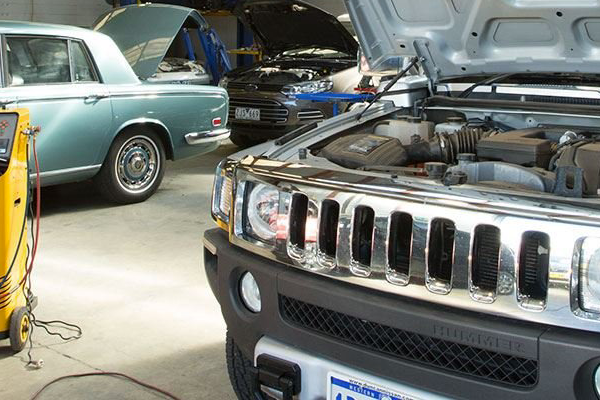 A Hummer is Being Worked on in a Garage With the Hood Open — A Plus Automotive Electrical in Lavington, NSW