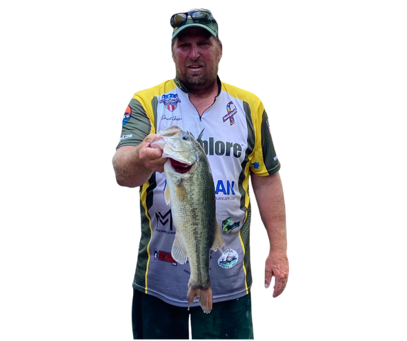Angler holding a large fish, wearing a white and yellow sponsor jersey and cap on a plain white background