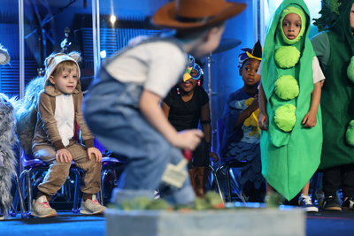 kids playing on the stage during a teachers pet preschool play for peter rabbit