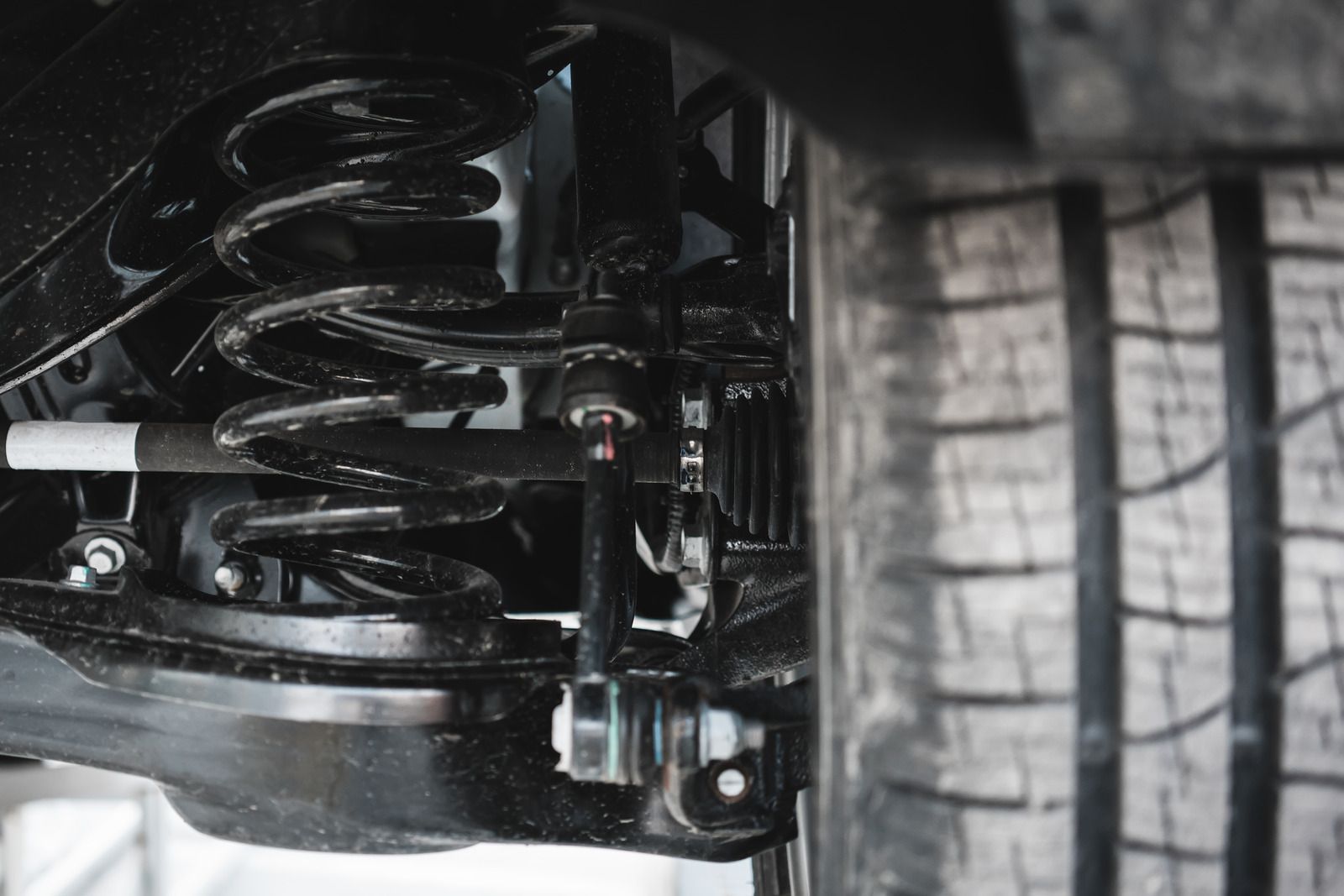 A close up of a shock absorber on a car.