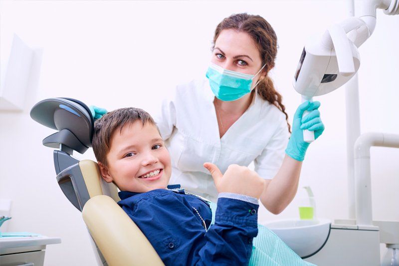 Happy Young Boy with a Dentist — Lodi, CA — Kevin L. Fleming DDS Happy Young Boy with a Dentist — Lodi, CA — Kevin L. Fleming DDS