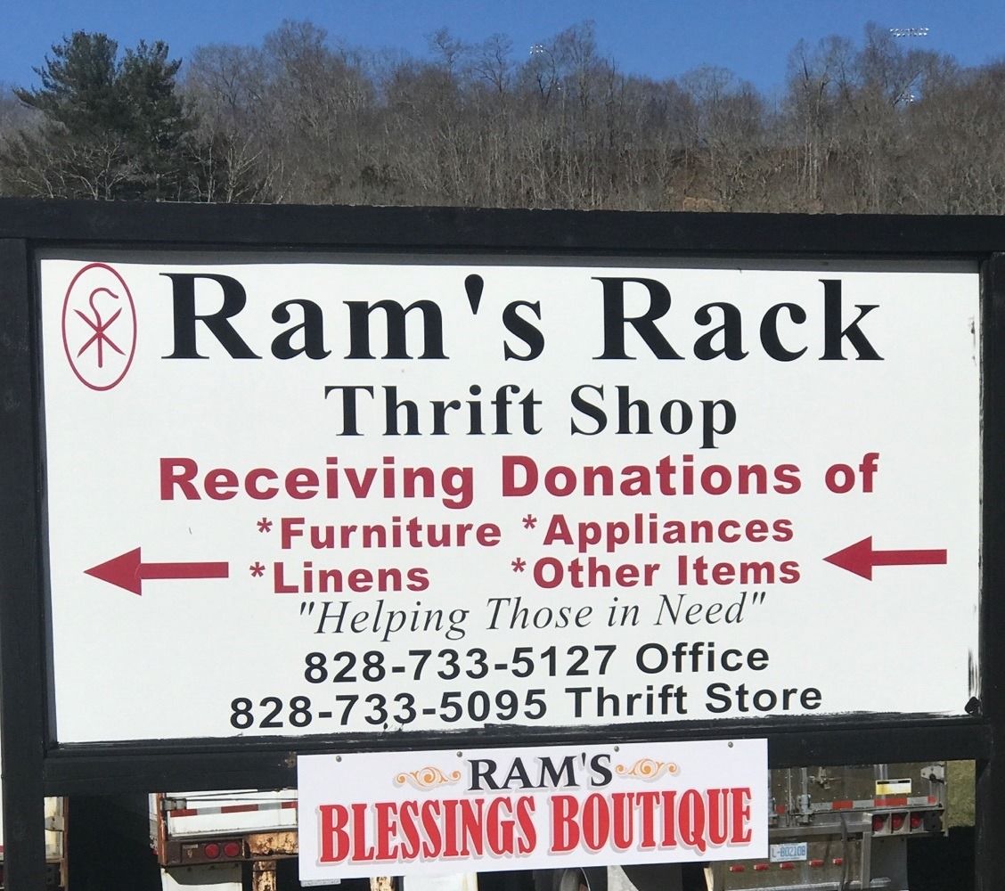 A sign for Ram’s Rack Thrift Shop listing donation items, phone numbers, and a smaller sign for Ram’s Blessings Boutique.