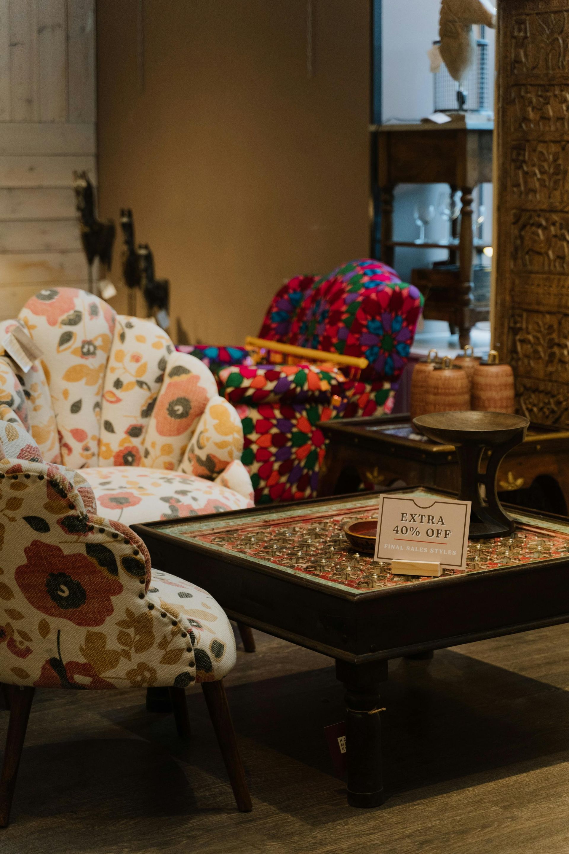 Floral-patterned chairs around a small table in a cozy indoor seating area