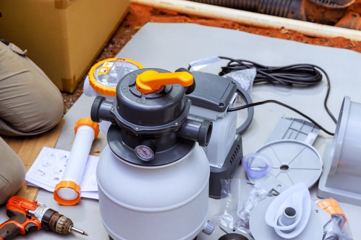 White spray paint canister with black-and-orange sprayer and accessories on a work surface