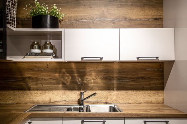 a kitchen with wooden cabinets and a stainless steel sink