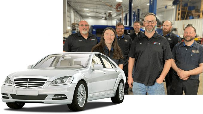Silver car in front of a team of mechanics in a garage setting. |  Johnson's Automotive