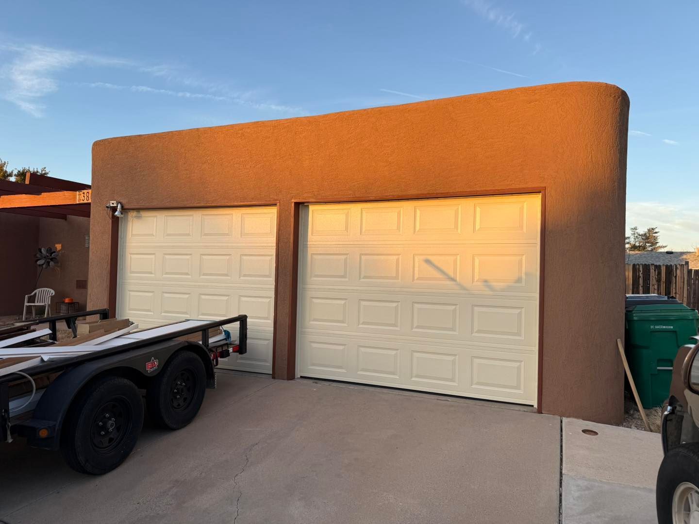 Grey garage door in a light-colored brick building under construction.