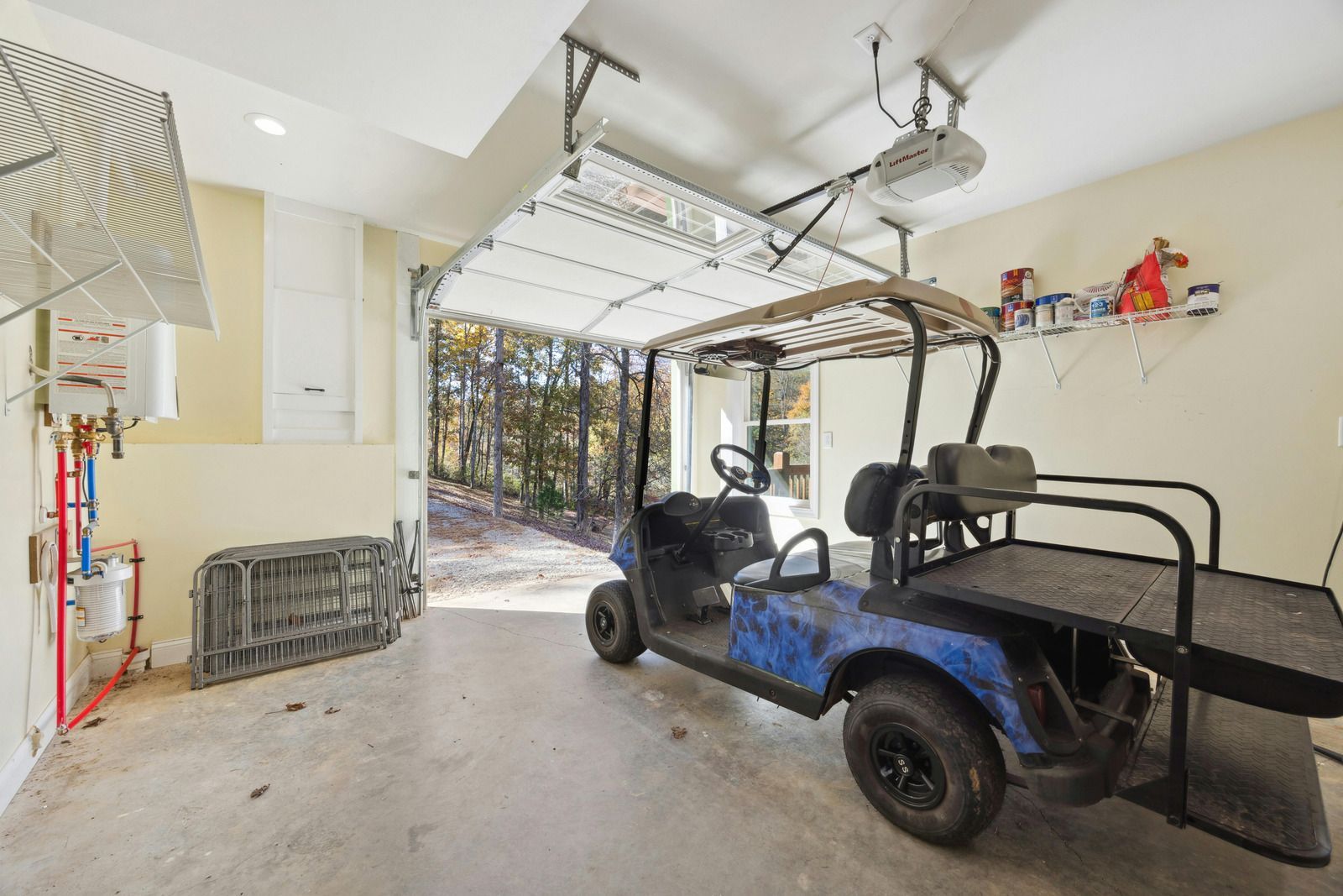 Construction of a garage. A person installs a garage door with window panels. Wooden framework visible.
