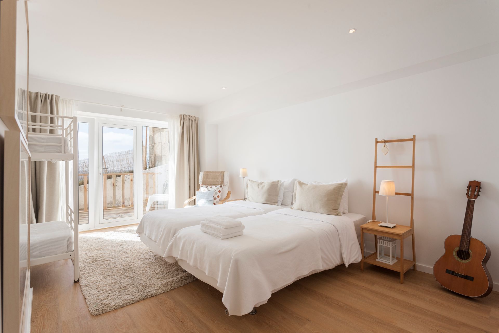 a bedroom with two beds and a guitar on the floor .