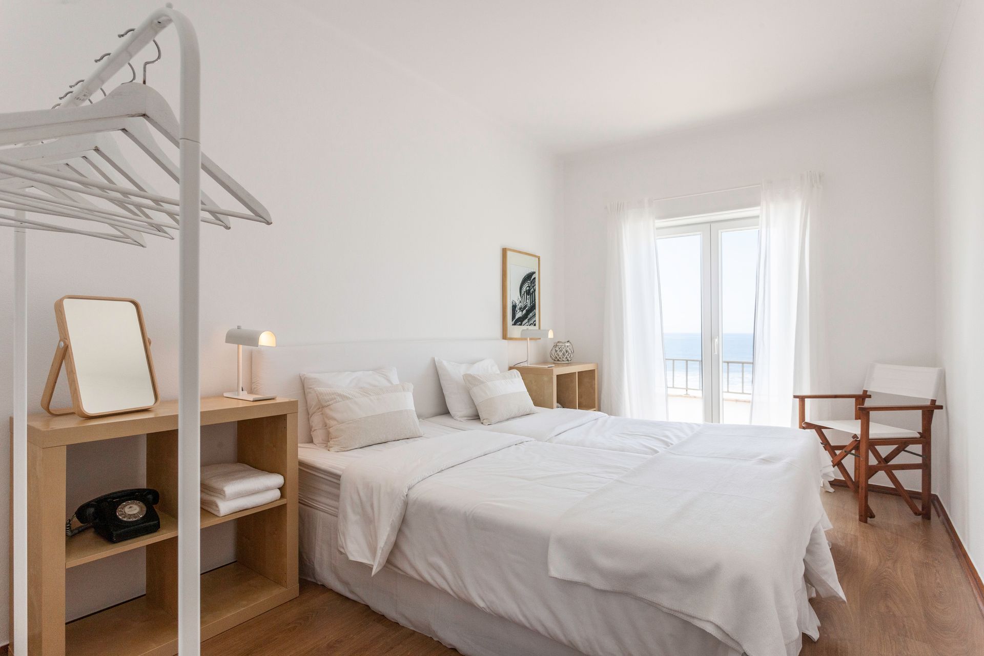 a bedroom with a large bed , a chair , a mirror and a closet .