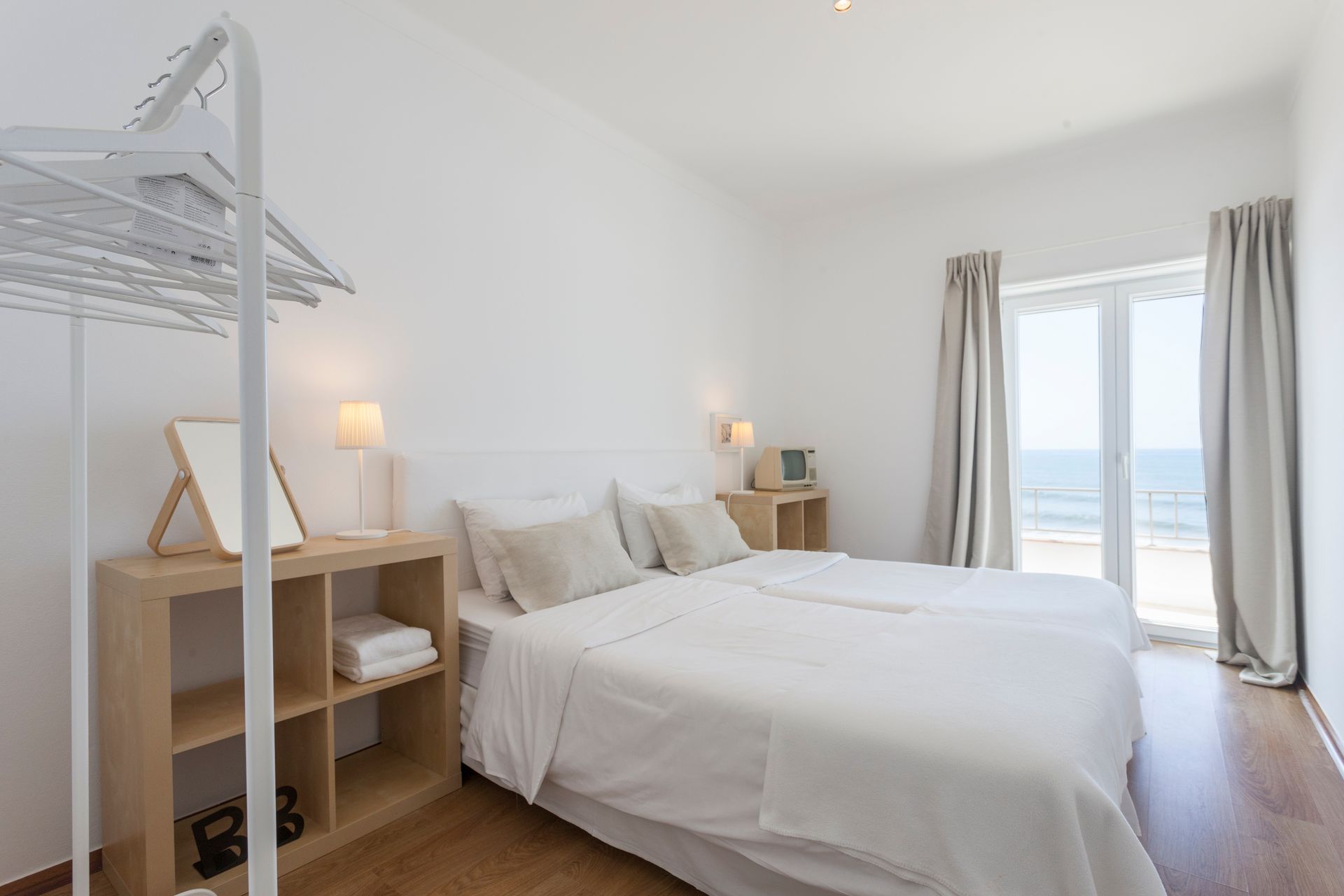 there is a large bed in the middle of the room with a large window .