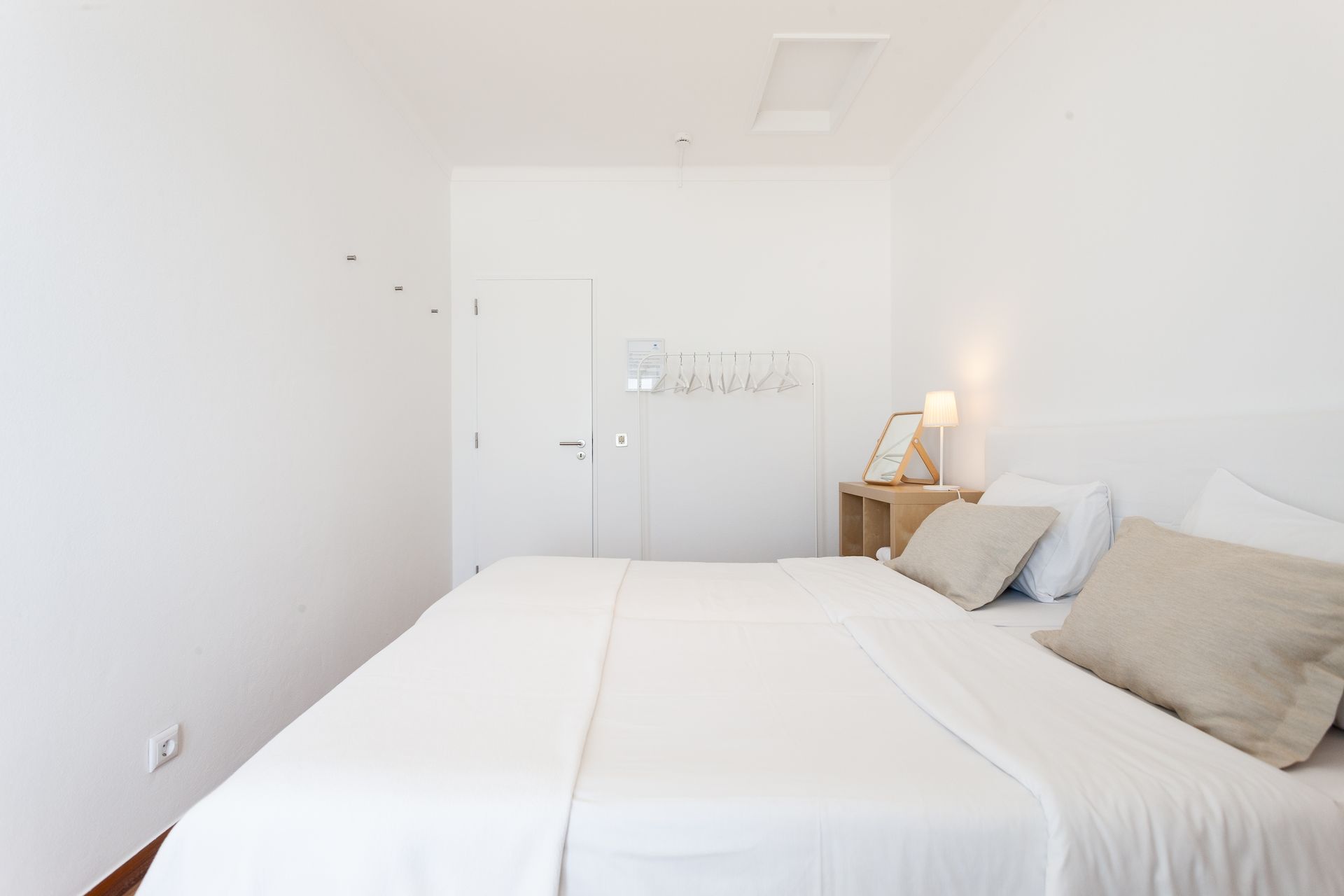 a bedroom with a large bed and white sheets
