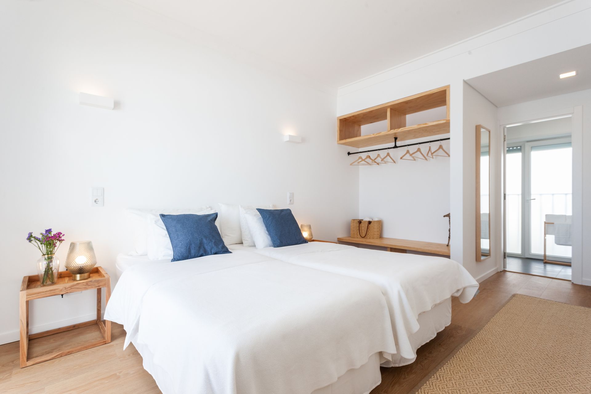 a bedroom with two beds , a nightstand and a mirror .