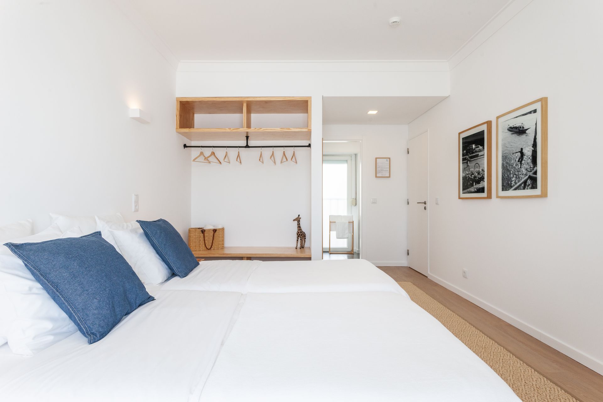 a bedroom with two beds and two pictures on the wall .