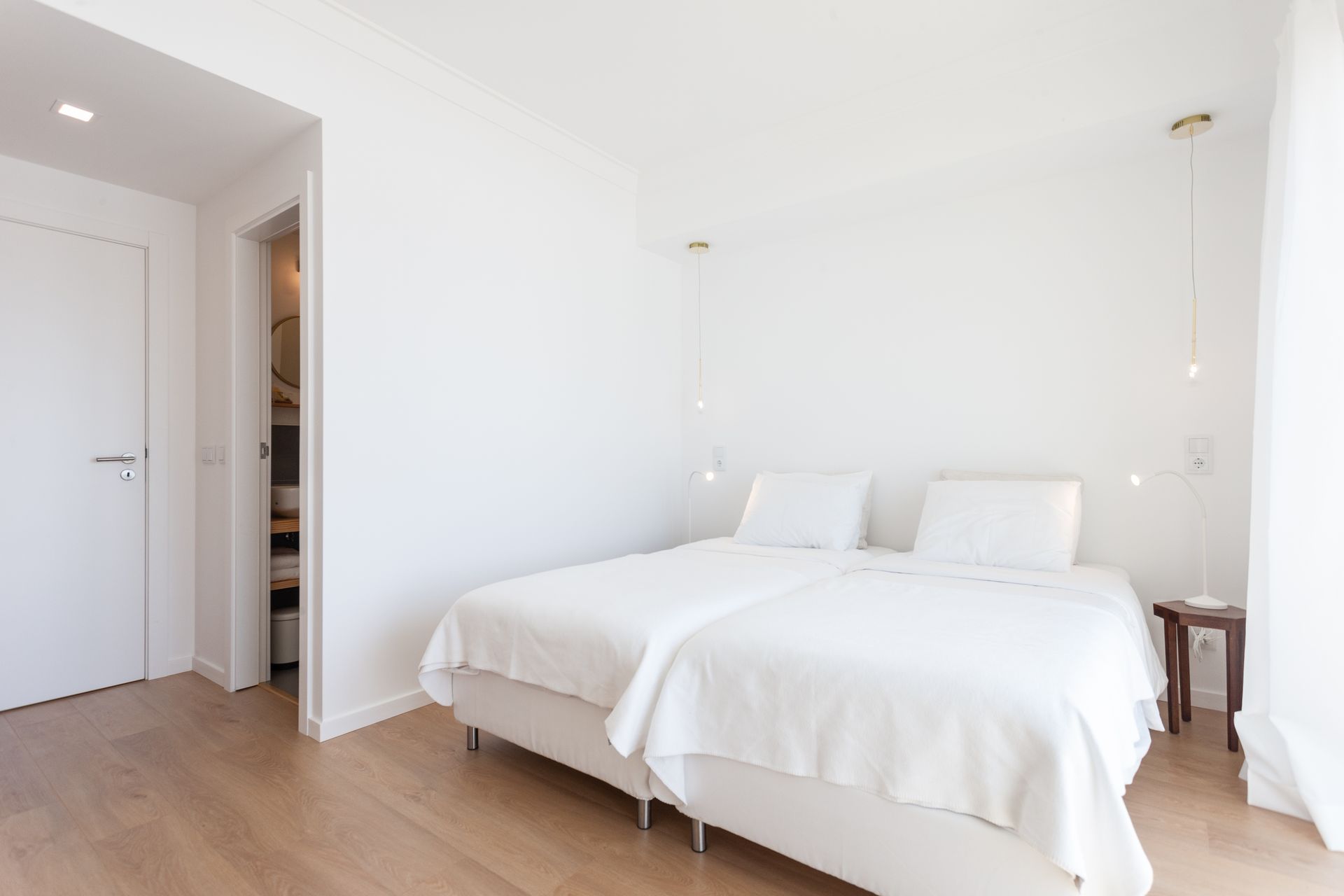a bedroom with two beds and a walk in closet .