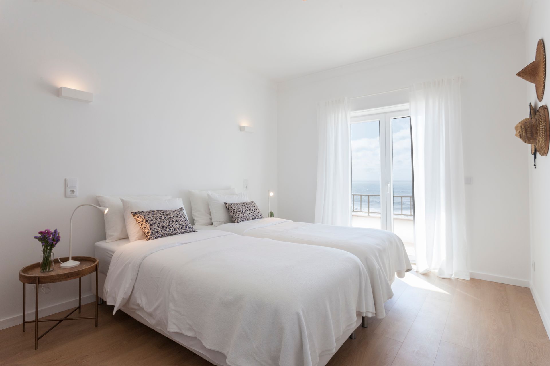 a bedroom with two beds and a sliding glass door .