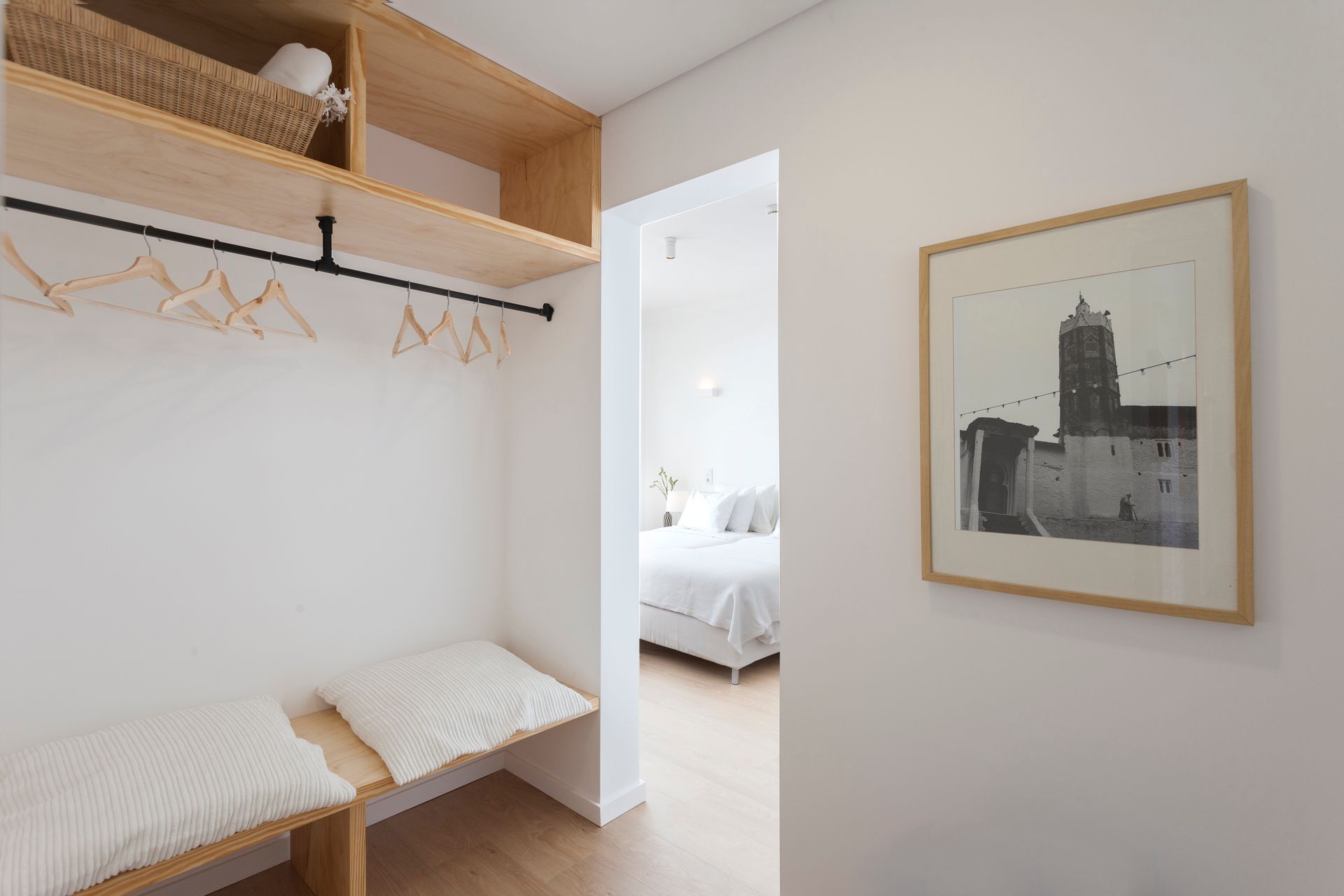 there is a picture of a building on the wall in the hallway .