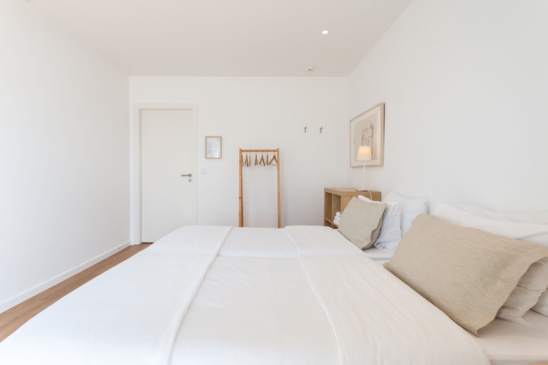 a bedroom with two beds and a hanger on the wall .