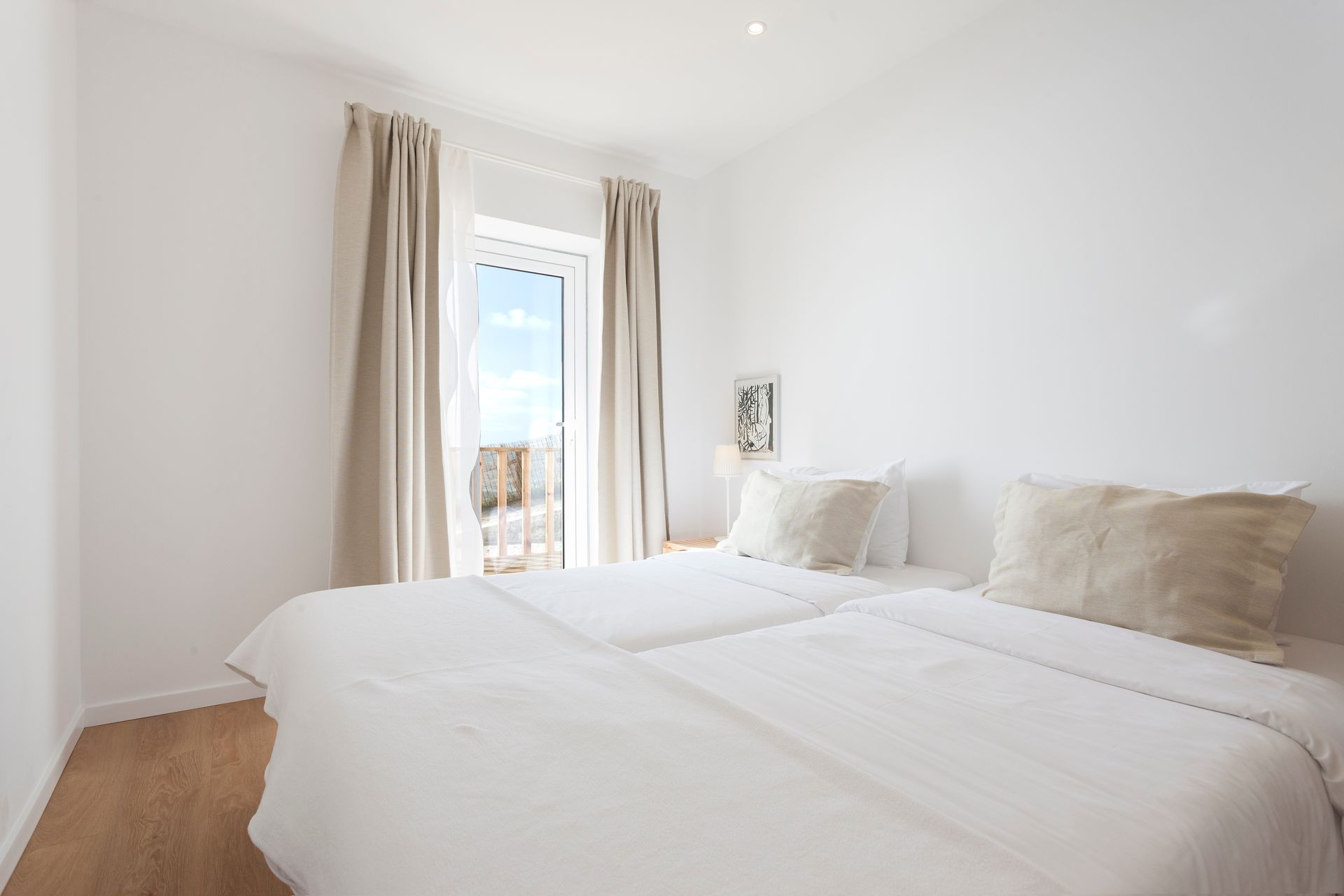 a bedroom with two beds and a sliding glass door .