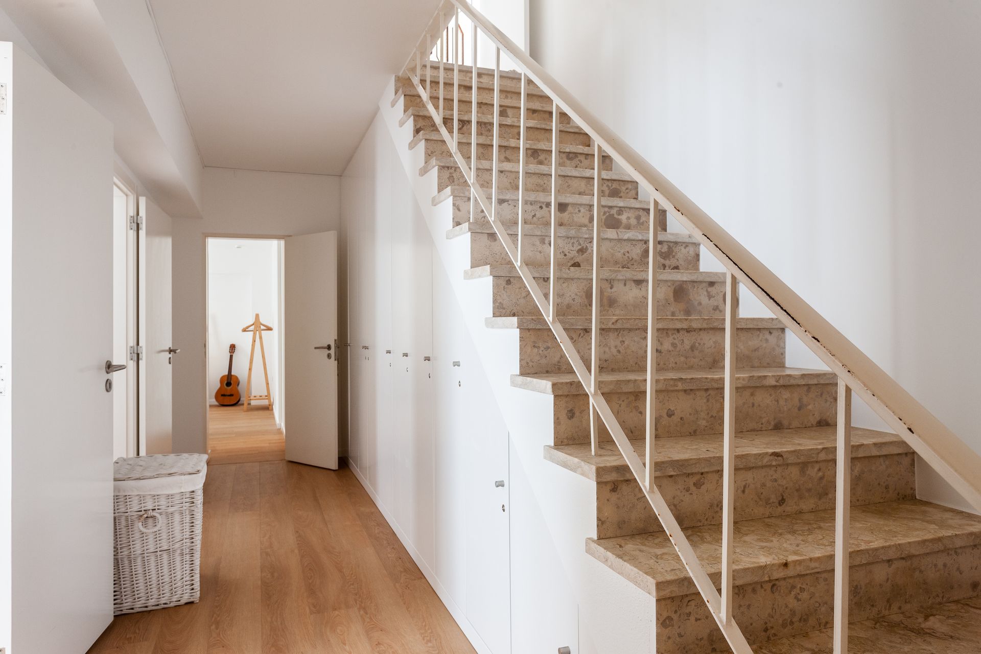 a hallway with stairs leading up to the second floor
