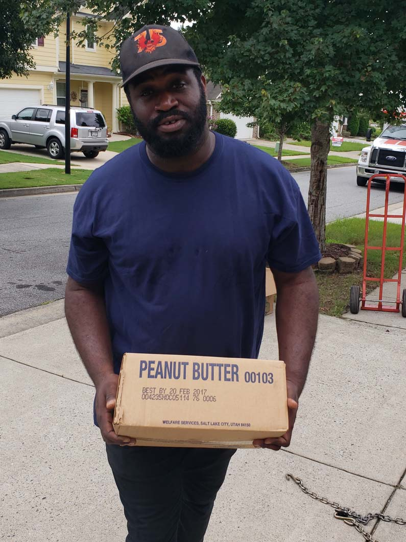 Man holding a box labeled 