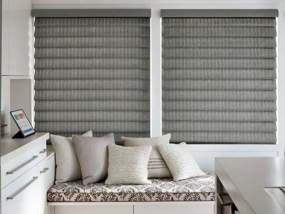 Gray Hunter Douglas Vingette® Roman Shades over a window seat near West Chester, OH, and Florence, KY