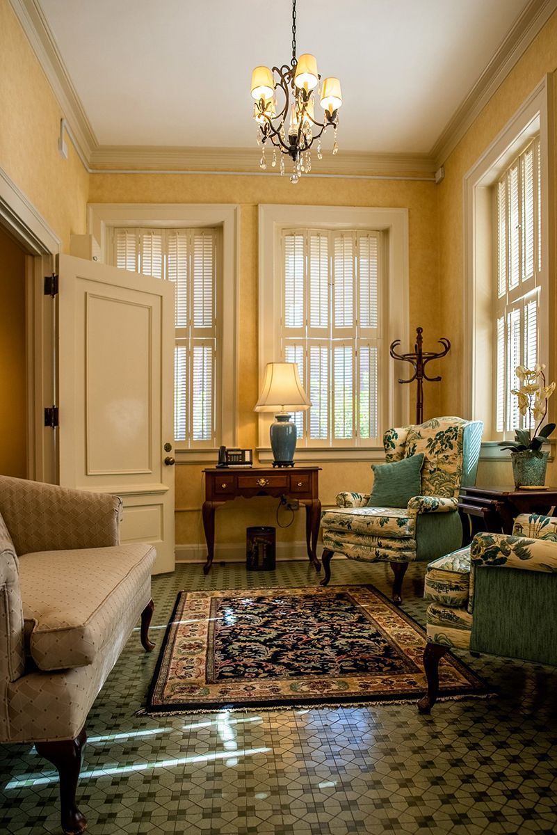 A living room filled with furniture and a chandelier.