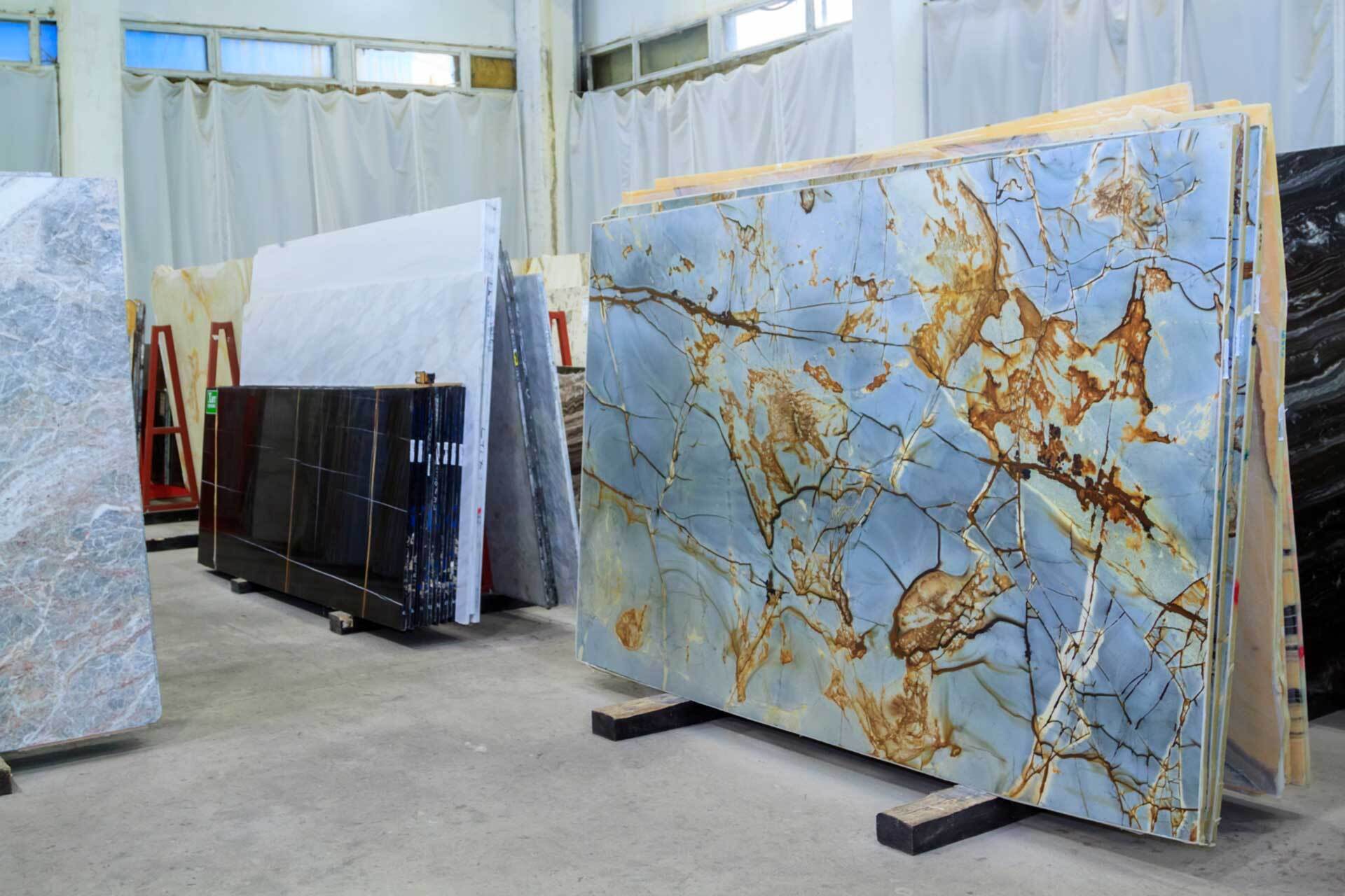 A bunch of marble slabs are stacked on top of each other in a room.