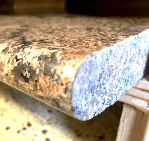 A close up of a granite counter top on a table.