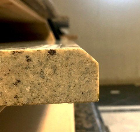A close up of a granite counter top in a kitchen.