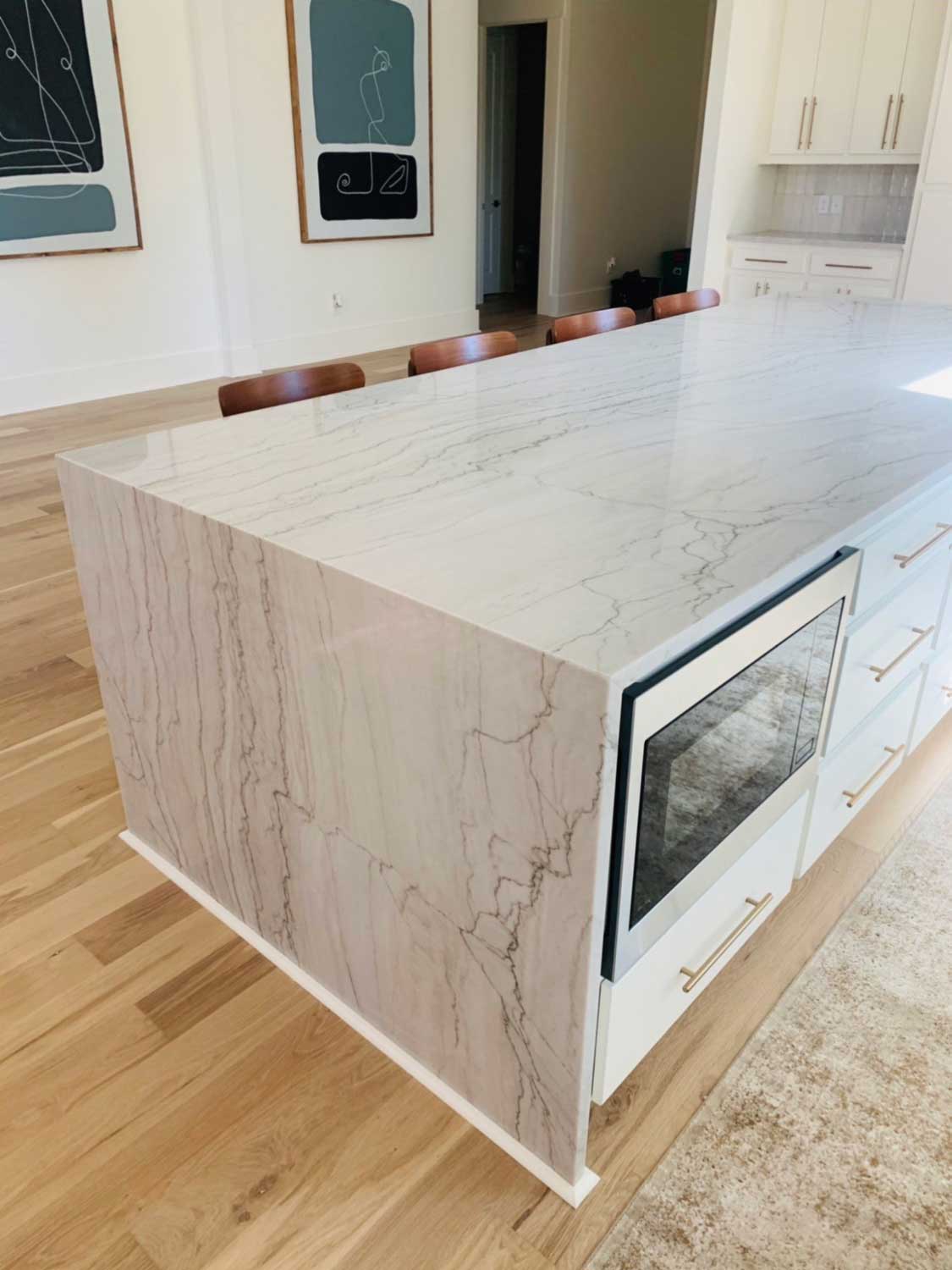A kitchen with a large island and a microwave