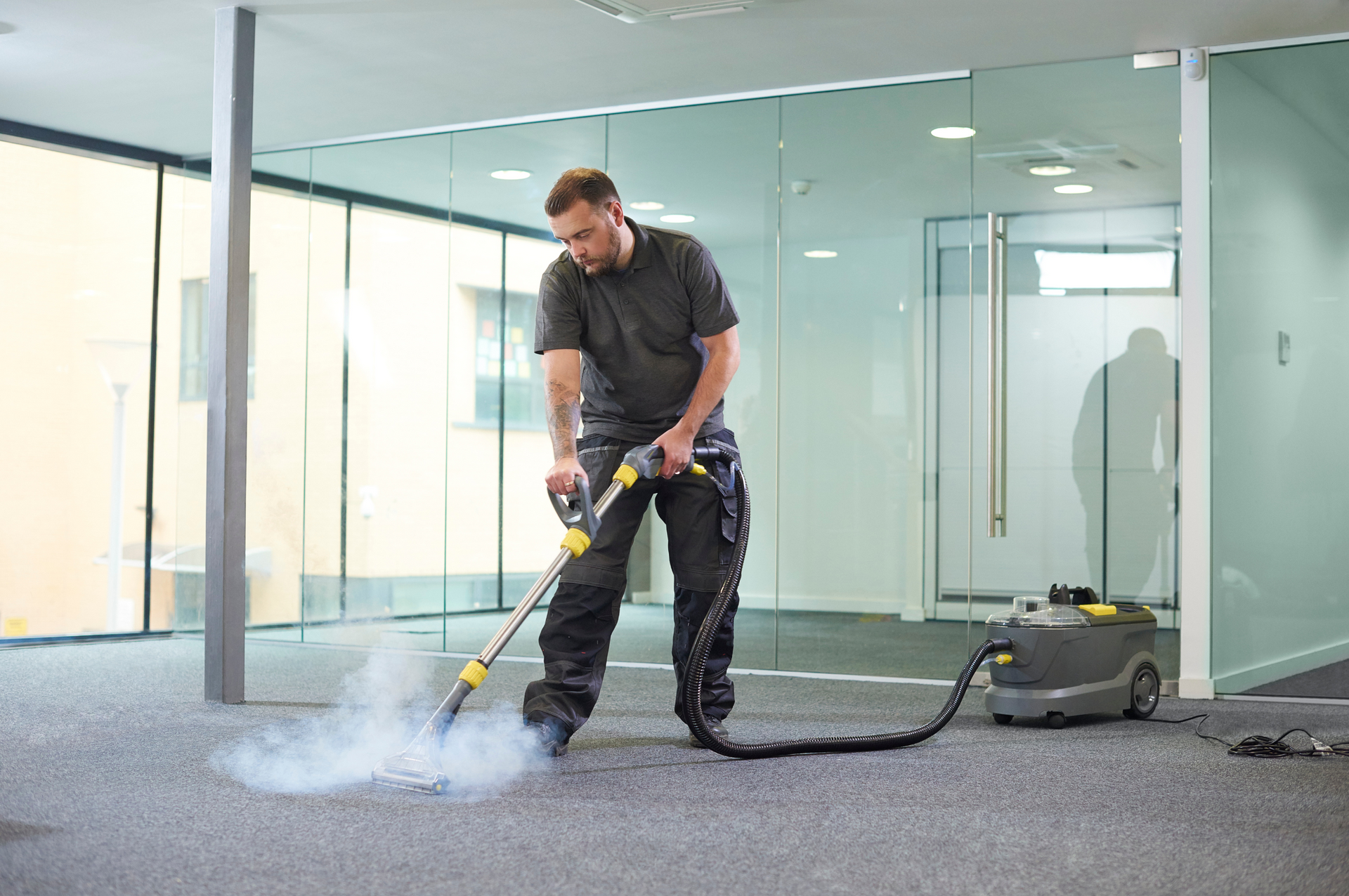 A Vacuum Cleaner Is Cleaning A Carpet In A Living Room — Carpet 2 Couch In Condon, QLD