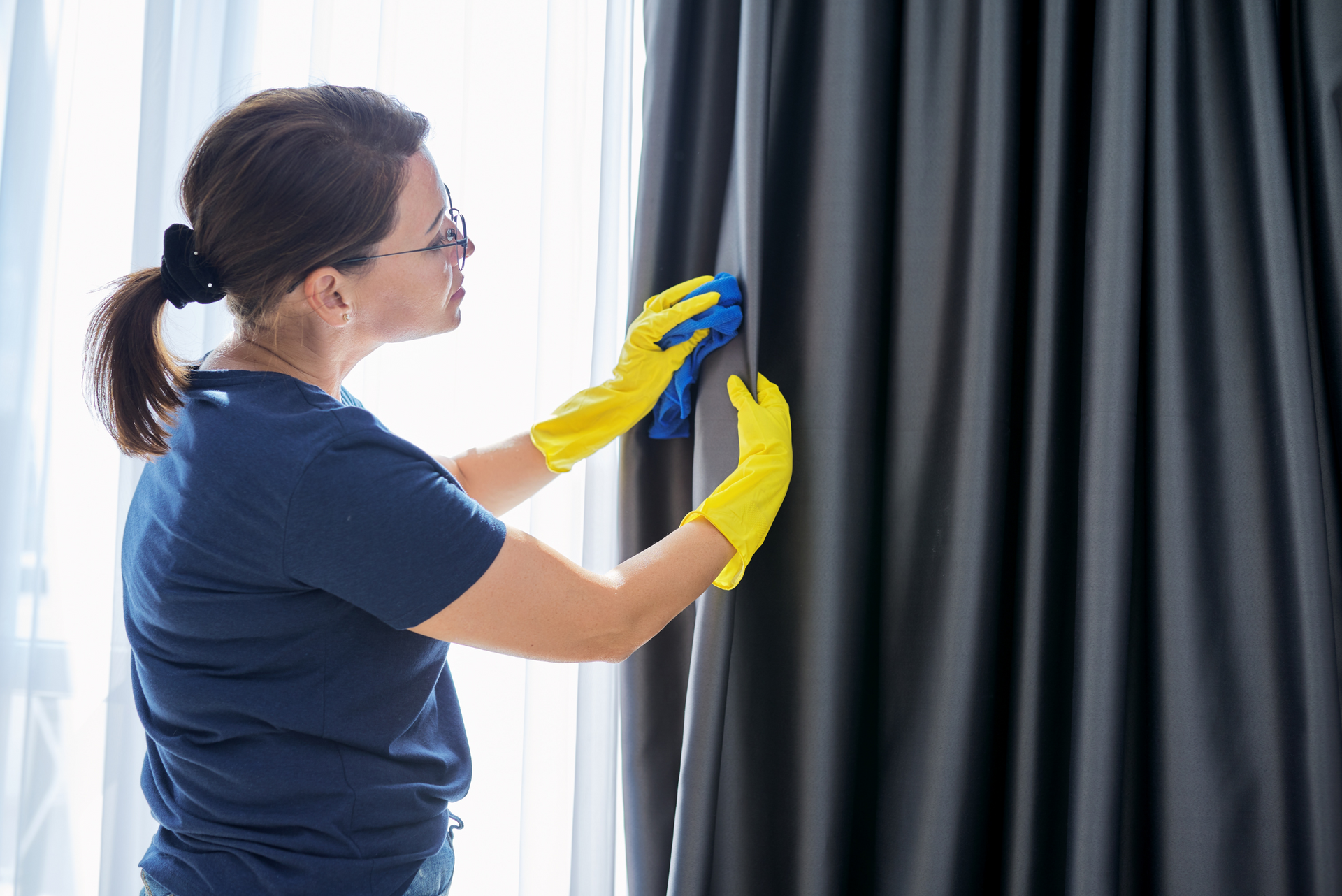 A Women Is Cleaning Curtain Cleaning with Window — Carpet 2 Couch In Condon, QLD