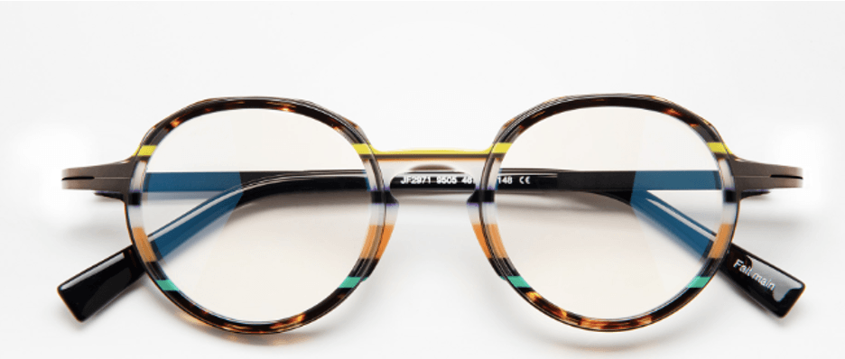 Lunettes à monture ronde à motifs, avec une touche de jaune et des branches bleues.